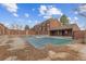 Community pool covered during off-season by brown condominiums under a bright sky at 343 W Lehow Ave # 22, Englewood, CO 80110