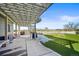 View of a backyard with a covered patio, artificial turf, and outdoor living space at 20783 E 50Th Pl, Denver, CO 80249