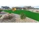 Backyard featuring lush artificial turf, a playground with a slide, and meticulously arranged rocks and plants at 20783 E 50Th Pl, Denver, CO 80249