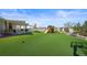 Landscaped backyard with artificial turf and playset at 20783 E 50Th Pl, Denver, CO 80249