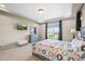 Cozy bedroom with a decorative tray ceiling, large windows, and stylish furniture at 20783 E 50Th Pl, Denver, CO 80249