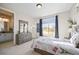 Bright bedroom with ensuite bathroom access and large window at 20783 E 50Th Pl, Denver, CO 80249