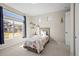Bright bedroom with large window and neutral decor at 20783 E 50Th Pl, Denver, CO 80249