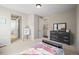 Bedroom featuring dresser, carpet floors, multiple entry doors, and an easel with art at 20783 E 50Th Pl, Denver, CO 80249
