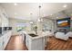 Spacious kitchen with a large island, stainless steel appliances, and an open layout connecting to the living room and backyard at 20783 E 50Th Pl, Denver, CO 80249