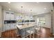 Bright kitchen featuring a granite island, stainless steel appliances, herringbone tile backsplash, and an adjoining dining area at 20783 E 50Th Pl, Denver, CO 80249
