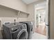 Laundry room with washer, dryer, and additional shelving at 20783 E 50Th Pl, Denver, CO 80249