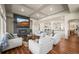 Spacious living room with fireplace, TV, coffered ceilings and wood floors at 20783 E 50Th Pl, Denver, CO 80249