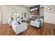 Bright living room with fireplace, TV, wood floors and lots of natural light at 20783 E 50Th Pl, Denver, CO 80249