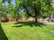 Well-maintained backyard with a lawn, large tree, and flower beds at 10109 W 68Th Ave, Arvada, CO 80004