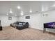 Finished basement with a sectional couch and a pinball machine at 10109 W 68Th Ave, Arvada, CO 80004