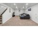 Spacious finished basement with stairs and a gray sectional sofa at 10109 W 68Th Ave, Arvada, CO 80004