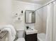 Bathroom featuring a toilet, sink, mirror, and shower with curtain at 10109 W 68Th Ave, Arvada, CO 80004
