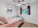 Cozy bedroom featuring a ceiling fan, carpet, and large window at 10109 W 68Th Ave, Arvada, CO 80004