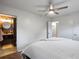 Bedroom with an ensuite bathroom, with white carpet, ceiling fan, and white walls at 10109 W 68Th Ave, Arvada, CO 80004