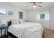Bright bedroom with white walls, carpet, and large bed with bedside tables at 10109 W 68Th Ave, Arvada, CO 80004