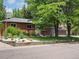 Attractive brick home showcasing lush front lawn, decorative rock features, and vibrant garden bed at 10109 W 68Th Ave, Arvada, CO 80004