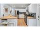 Modern kitchen featuring white cabinets, stainless steel appliances, butcher block counters, and a breakfast bar at 10109 W 68Th Ave, Arvada, CO 80004