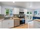 Bright kitchen featuring stainless steel appliances, stylish backsplash, and wood countertops at 10109 W 68Th Ave, Arvada, CO 80004