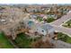 Aerial shot of home with fenced yard, trees and neighboring houses down the street at 9340 W Burgundy Ave, Littleton, CO 80123