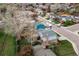 Aerial view of a home with a big backyard, outdoor kitchen, and a blue home next door at 9340 W Burgundy Ave, Littleton, CO 80123