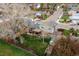 Aerial view of backyard featuring covered patio, shed, and mature trees, fully fenced in for privacy at 9340 W Burgundy Ave, Littleton, CO 80123