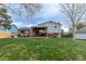 Expansive backyard with mature trees, a patio, pergola and outbuilding at 9340 W Burgundy Ave, Littleton, CO 80123