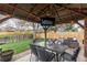 Backyard patio area with a pergola, seating, and a TV at 9340 W Burgundy Ave, Littleton, CO 80123