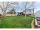 Lush backyard with mature trees, a patio, pergola, and shed at 9340 W Burgundy Ave, Littleton, CO 80123