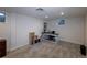 Finished basement area with neutral carpet, a built in bookcase and a desk area at 9340 W Burgundy Ave, Littleton, CO 80123