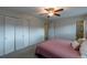 Comfortable bedroom with a ceiling fan, closet, and ensuite bathroom access at 9340 W Burgundy Ave, Littleton, CO 80123