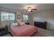 Inviting bedroom with two windows, a ceiling fan, and carpeted flooring at 9340 W Burgundy Ave, Littleton, CO 80123
