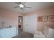 Cozy bedroom featuring a ceiling fan, white closet doors, and stylish wall decor at 9340 W Burgundy Ave, Littleton, CO 80123