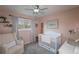 Charming Bedroom with a crib, rocking chair, and soft pastel colors at 9340 W Burgundy Ave, Littleton, CO 80123