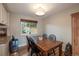 Dining area featuring hardwood floors and a large window overlooking the yard at 9340 W Burgundy Ave, Littleton, CO 80123