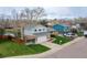 Two-story home with brick and siding, a well-manicured lawn, and an attached two-car garage on a tree-lined street at 9340 W Burgundy Ave, Littleton, CO 80123