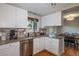 Modern kitchen featuring white cabinets, granite countertops, and stainless steel appliances at 9340 W Burgundy Ave, Littleton, CO 80123