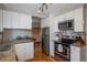Well-equipped kitchen with granite counters, stainless steel appliances, and white cabinetry at 9340 W Burgundy Ave, Littleton, CO 80123