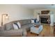 Spacious living room boasts a large sectional sofa, fireplace, and hardwood flooring at 9340 W Burgundy Ave, Littleton, CO 80123
