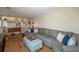 Open living area with hardwood floors, a comfortable sofa, and access to the upper level at 9340 W Burgundy Ave, Littleton, CO 80123