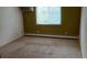 Bedroom with carpeted floor, neutral wall color, and natural light from a window at 8828 E Florida Ave # 103, Denver, CO 80247