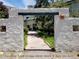 The entrance features a decorative sun decoration, stucco walls, and lush landscaping at 8828 E Florida Ave # 103, Denver, CO 80247
