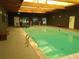Bright indoor pool area featuring a large pool, skylights, and a relaxing atmosphere at 8828 E Florida Ave # 103, Denver, CO 80247