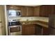 Kitchen with stainless steel appliances, wood cabinets and granite countertops at 8828 E Florida Ave # 103, Denver, CO 80247