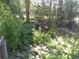 Rock garden landscaping with lush plants and a small rocky waterfall feature at 8828 E Florida Ave # 103, Denver, CO 80247