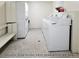 Well-maintained laundry room featuring multiple white washers and dryers for resident convenience at 8828 E Florida Ave # 103, Denver, CO 80247