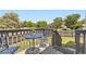 Back deck with metal table and chairs and wood rails overlooking green yard at 10890 Stuart Ct, Westminster, CO 80031