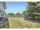 Back yard with a hammock under a pine tree with wood fence surrounding at 10890 Stuart Ct, Westminster, CO 80031