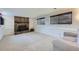 Spacious basement with a brick fireplace, carpeted floors, and windows providing natural light at 10890 Stuart Ct, Westminster, CO 80031