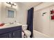 Bathroom features vanity with sink, toilet, and shower/tub combo with blue shower curtain at 10890 Stuart Ct, Westminster, CO 80031